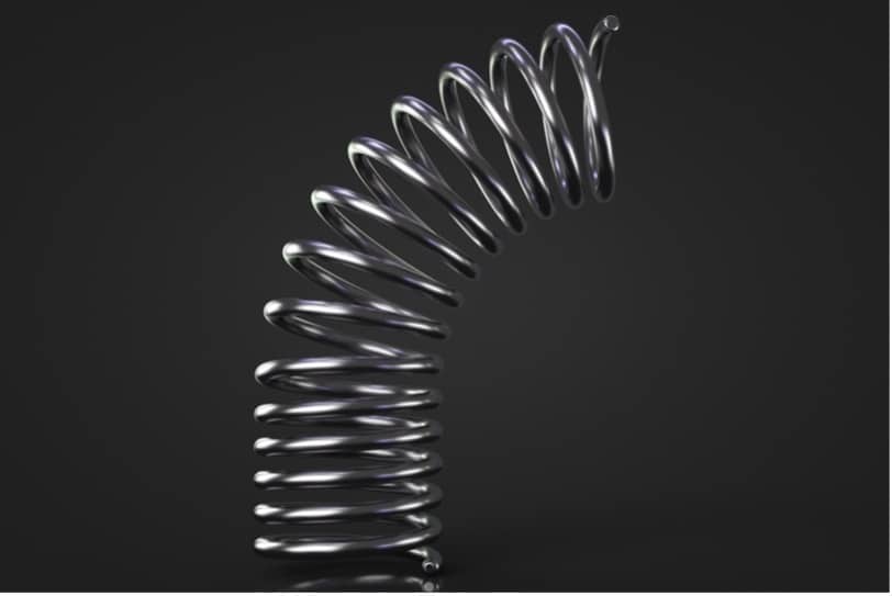 A metal spring on a black background