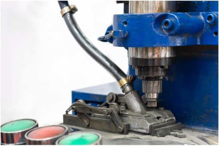 Close-up of a machine with a blue metal part