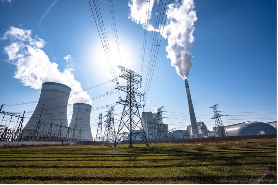 Power lines and towers with smoke coming out of them